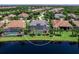 Stunning aerial view of a home with screened-in pool and lake access in a beautiful, landscaped community at 16628 Berwick Ter, Lakewood Ranch, FL 34202