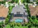 Breathtaking aerial view of this home featuring a pristine screened pool area and lush landscaping at 16628 Berwick Ter, Lakewood Ranch, FL 34202