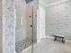 Modern bathroom showcasing a glass enclosed shower and elegant wallpaper at 16628 Berwick Ter, Lakewood Ranch, FL 34202
