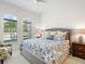 Bedroom with natural light from arched windows and a cozy king size bed at 16628 Berwick Ter, Lakewood Ranch, FL 34202