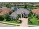 Stunning waterfront home with lush landscaping, tile roof, and brick paver driveway at 16628 Berwick Ter, Lakewood Ranch, FL 34202