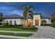 Beautiful single-Gathering home featuring a paver driveway, arched entryway, and well-manicured lawn at 16628 Berwick Ter, Lakewood Ranch, FL 34202