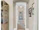 Hallway leading to rooms with decorative mirrors and paintings enhancing the elegance at 16628 Berwick Ter, Lakewood Ranch, FL 34202