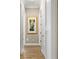 Hallway featuring wood flooring and a framed floral painting at 16628 Berwick Ter, Lakewood Ranch, FL 34202