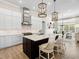 Open-concept kitchen features a large island, stainless steel appliances, and elegant pendant lighting at 16628 Berwick Ter, Lakewood Ranch, FL 34202