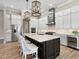 Bright kitchen with white cabinetry, stainless steel appliances, large island and bar stool seating at 16628 Berwick Ter, Lakewood Ranch, FL 34202