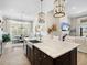 Spacious kitchen with a large island and stainless steel farmhouse sink overlooking the living area at 16628 Berwick Ter, Lakewood Ranch, FL 34202