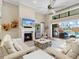 Spacious living room features a fireplace, TV, and sliding glass doors that open to the backyard at 16628 Berwick Ter, Lakewood Ranch, FL 34202