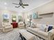 Bright living room with large windows, comfortable seating, and stylish decor at 16628 Berwick Ter, Lakewood Ranch, FL 34202