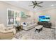 Cozy living room with neutral tones, stylish furniture, and a ceiling fan at 16628 Berwick Ter, Lakewood Ranch, FL 34202