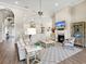 Open concept living room flows into kitchen, featuring wood floors, fireplace, and neutral color palette at 16628 Berwick Ter, Lakewood Ranch, FL 34202
