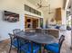 Elegant outdoor dining area with comfortable seating and views of the home's open concept interior and beautiful backyard at 16628 Berwick Ter, Lakewood Ranch, FL 34202
