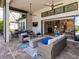 A large, screened patio with multiple seating areas seamlessly connects to the home's bright and open interior living spaces at 16628 Berwick Ter, Lakewood Ranch, FL 34202