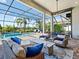 Inviting outdoor living area with a cozy seating area, a fire pit, and serene views of the pool and picturesque backyard at 16628 Berwick Ter, Lakewood Ranch, FL 34202
