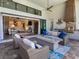 Cozy outdoor living area with fireplace and outdoor kitchen seamlessly connects to the indoor living space for year-round enjoyment at 16628 Berwick Ter, Lakewood Ranch, FL 34202