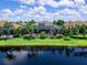 Beautiful backyard pool with screened enclosure, lush landscaping, and serene lake views at 16628 Berwick Ter, Lakewood Ranch, FL 34202