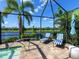Tranquil pool deck featuring comfortable lounge chairs and views of the serene lake and lush landscaping at 16628 Berwick Ter, Lakewood Ranch, FL 34202