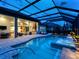 Luxurious screened pool area featuring a spa, lounge area, and seamless indoor-outdoor living with an open floor plan at 16628 Berwick Ter, Lakewood Ranch, FL 34202