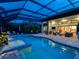 Beautiful screened pool area with a spa, outdoor seating, and seamless access to indoor living space at 16628 Berwick Ter, Lakewood Ranch, FL 34202