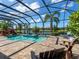 Relax by the pool and spa surrounded by lush tropical landscaping and scenic lake views in this screened lanai at 16628 Berwick Ter, Lakewood Ranch, FL 34202