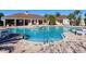 Community pool featuring a zero entry access, sun loungers, and covered seating areas at 16628 Berwick Ter, Lakewood Ranch, FL 34202