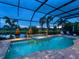 Inviting screened-in pool and spa with brick surround, palm trees, and serene views at 16628 Berwick Ter, Lakewood Ranch, FL 34202