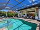 Enjoy this sparkling swimming pool and covered patio with an outdoor kitchen perfect for outdoor entertaining and relaxation at 16628 Berwick Ter, Lakewood Ranch, FL 34202