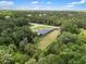 Overhead view of the property displaying the home's positioning among the surrounding trees at 17211 Drayton Ln, Port Charlotte, FL 33948