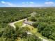 Aerial view of the property surrounded by lush trees, showcasing the home's serene location at 17211 Drayton Ln, Port Charlotte, FL 33948