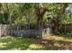Fenced backyard featuring mature trees, offering privacy and a natural setting at 17211 Drayton Ln, Port Charlotte, FL 33948