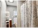 Compact bathroom featuring a shower with patterned curtain, vanity, and essential amenities for everyday convenience at 17211 Drayton Ln, Port Charlotte, FL 33948