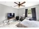 Comfortable bedroom with tile flooring, a ceiling fan, and a window, perfect for relaxation and personalization at 17211 Drayton Ln, Port Charlotte, FL 33948