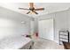 Simple bedroom with tile floors, a ceiling fan, closet, and natural light, offering a basic yet functional living space at 17211 Drayton Ln, Port Charlotte, FL 33948