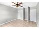 Neutral bedroom features tile floors, a ceiling fan, and a closet, offering a blank canvas for personalization at 17211 Drayton Ln, Port Charlotte, FL 33948