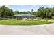 Beautiful home featuring a screened porch and mature landscaping at 17211 Drayton Ln, Port Charlotte, FL 33948