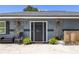 Elegant front entrance with decorative stone accents and a well-kept garden at 17211 Drayton Ln, Port Charlotte, FL 33948