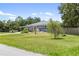 Charming single-story home with a well-manicured lawn and mature landscaping at 17211 Drayton Ln, Port Charlotte, FL 33948