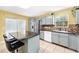 Charming kitchen features an island and stainless steel appliances at 17211 Drayton Ln, Port Charlotte, FL 33948