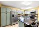 Charming kitchen with gray cabinets, mosaic backsplash, and island seating at 17211 Drayton Ln, Port Charlotte, FL 33948