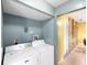 Practical laundry room with washer, dryer, and storage, providing functionality and convenience for household tasks at 17211 Drayton Ln, Port Charlotte, FL 33948