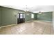 Spacious living room featuring tile flooring and a classic chandelier at 17211 Drayton Ln, Port Charlotte, FL 33948