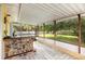 An outdoor patio space featuring a stone counter with a view of the yard at 17211 Drayton Ln, Port Charlotte, FL 33948
