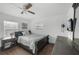 Cozy bedroom with hardwood floors, ceiling fan, and ample natural light at 2005 Gillespie Ave, Sarasota, FL 34234
