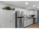 Modern kitchen featuring stainless steel appliances, granite countertops and luxury vinyl plank flooring at 2005 Gillespie Ave, Sarasota, FL 34234