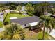 Aerial view of the home with spacious backyard, covered patio, and mature landscaping at 211 22Nd Street Ne Ct, Bradenton, FL 34208