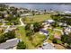 Aerial view of home surrounded by lush landscaping, a circular driveway, and water views at 211 22Nd Street Ne Ct, Bradenton, FL 34208