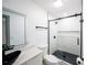 Modern bathroom featuring black fixtures, a stylish vessel sink, and a tiled shower with glass door at 211 22Nd Street Ne Ct, Bradenton, FL 34208