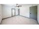 This large bedroom features white walls, grey trim, a ceiling fan, and beautiful marble floors at 211 22Nd Street Ne Ct, Bradenton, FL 34208