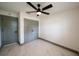 This bedroom includes a closet, ceiling fan, bright white walls, and beautiful marble floors at 211 22Nd Street Ne Ct, Bradenton, FL 34208