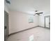 A bright room with a ceiling fan, grey trim, and a sleek door with a large window at 211 22Nd Street Ne Ct, Bradenton, FL 34208